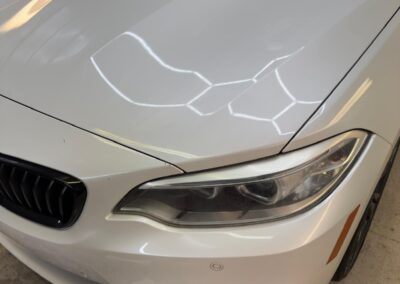 White BMW hood before mobile detailing in Central Arkansas