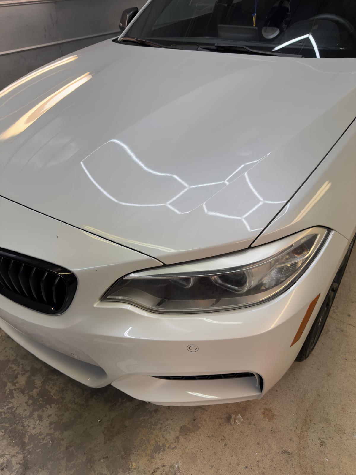 White BMW hood before mobile detailing in Central Arkansas